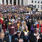 Thousands faced the American flag and recited the Pledge of Allegiance during Saturday's "Mountaineer Workers Rising" Rally on the front steps of the West Virginia Capitol. National and local leaders addressed the crowd, calling for those in attendance to be political active and to vote for legislators who support worker-friendly initiatives in the Legislature. Photo by the West Virginia Press Association